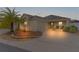 Attractive tan house with palm tree and driveway at dusk at 9224 Se 167Th Ford St, The Villages, FL 32162