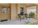 Covered entryway with two chairs and small potted plant at 9224 Se 167Th Ford St, The Villages, FL 32162