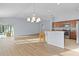 Open concept kitchen and dining area with wood floors at 9224 Se 167Th Ford St, The Villages, FL 32162