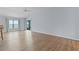 Light-toned living room with hardwood floors and sliding glass doors at 9224 Se 167Th Ford St, The Villages, FL 32162