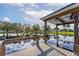 Covered dock with lift and hammock overlooking lake at 929 Sunset Cir, Tavares, FL 32778