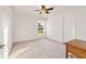 Well-lit bedroom with ceiling fan and neutral decor at 10349 Silver Maple Ave, Oxford, FL 34484