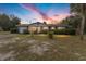 Brick ranch house with a spacious yard, at sunset at 1550 Miller Blvd, Fruitland Park, FL 34731