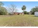 Brick house exterior with a spacious backyard and shed at 1550 Miller Blvd, Fruitland Park, FL 34731