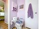 Lavender bathroom with toilet and grab bar at 1559 Nassau Cir, Tavares, FL 32778