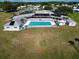 Aerial view of community pool with solar panels and surrounding grounds at 1559 Nassau Cir, Tavares, FL 32778