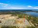 Aerial view of a house in a new development with a lake nearby at 16178 Se 104Th Ter, Summerfield, FL 34491