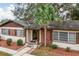 Brick ranch home with palm tree and landscaped yard at 1801 Vine St, Leesburg, FL 34748