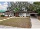 Ranch home with carport and mature trees at 1801 Vine St, Leesburg, FL 34748