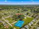 Aerial view showcasing community amenities, including a clubhouse and tennis courts at 17925 Se 100Th Ter, Summerfield, FL 34491
