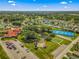 Community overview featuring clubhouse, tennis courts, pond, and parking areas at 17925 Se 100Th Ter, Summerfield, FL 34491