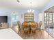 Bright dining room with wood table and chairs, offering access to other rooms at 17925 Se 100Th Ter, Summerfield, FL 34491