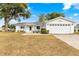 Single story home with attached garage and landscaped yard at 17925 Se 100Th Ter, Summerfield, FL 34491