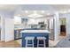 Modern kitchen with stainless steel appliances and blue island at 17925 Se 100Th Ter, Summerfield, FL 34491