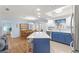 Modern kitchen with stainless steel appliances and blue island at 17925 Se 100Th Ter, Summerfield, FL 34491
