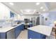 Modern kitchen with stainless steel appliances and blue island at 17925 Se 100Th Ter, Summerfield, FL 34491