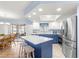 Modern kitchen with stainless steel appliances and blue island at 17925 Se 100Th Ter, Summerfield, FL 34491
