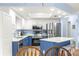 Modern kitchen with stainless steel appliances and blue island at 17925 Se 100Th Ter, Summerfield, FL 34491