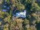 An aerial view of a home with a metal roof and a screened enclosure at 22740 County Road 44A, Eustis, FL 32736