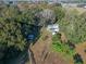 Aerial view showing a house and other structures on a wooded lot at 22740 County Road 44A, Eustis, FL 32736