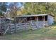 Wooden animal shelter with a gated entrance and fenced area at 22740 County Road 44A, Eustis, FL 32736