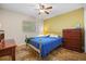 Cozy bedroom with a brass bed frame and ample closet space at 22740 County Road 44A, Eustis, FL 32736