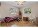 Cozy bedroom with wood floors and plenty of natural light at 22740 County Road 44A, Eustis, FL 32736
