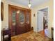 Elegant entryway with wood door, stained glass, and tile flooring at 22740 County Road 44A, Eustis, FL 32736