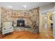 Stone fireplace with built-in shelving and hardwood floors at 22740 County Road 44A, Eustis, FL 32736