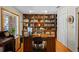 Home office with built-in shelves and a large desk at 22740 County Road 44A, Eustis, FL 32736