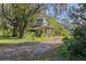 Rustic house exterior nestled amongst lush greenery at 22740 County Road 44A, Eustis, FL 32736