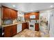 Well-equipped kitchen featuring wood cabinets and granite counters at 22740 County Road 44A, Eustis, FL 32736