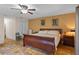 Main bedroom with wood sleigh bed and ceiling fan at 22740 County Road 44A, Eustis, FL 32736