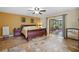 Large main bedroom with wood flooring and access to a screened porch at 22740 County Road 44A, Eustis, FL 32736