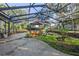 Spacious screened patio with hot tub and tropical landscaping at 22740 County Road 44A, Eustis, FL 32736