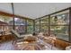 Relaxing sunroom with tiled floors, lounge chairs, and natural light at 22740 County Road 44A, Eustis, FL 32736