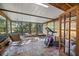 Bright sunroom with tiled floor, comfy seating, and large windows at 22740 County Road 44A, Eustis, FL 32736