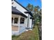 Charming white house with black accents and a spacious porch at 235 Hyde Park Ave, Eustis, FL 32726