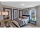 Modern bedroom with navy headboard and geometric wall design at 2986 Supermarine Rd, Tavares, FL 32778