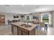 Island kitchen with stainless steel appliances and breakfast bar at 2986 Supermarine Rd, Tavares, FL 32778
