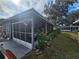 Home exterior with a screened-in porch and landscaping at 30 Riverview Dr, Fruitland Park, FL 34731