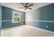 Bedroom with large window, ceiling fan and wood-look floors at 3141 Britannia Blvd # D, Kissimmee, FL 34747