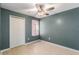 Simple bedroom with wood-look floors and ceiling fan at 3141 Britannia Blvd # D, Kissimmee, FL 34747