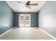 Main bedroom with hardwood floors and access to a balcony at 3141 Britannia Blvd # D, Kissimmee, FL 34747