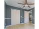 Bedroom with double doors to closet and ceiling fan at 3141 Britannia Blvd # D, Kissimmee, FL 34747