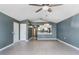 Open living room with view into kitchen and hardwood floors at 3141 Britannia Blvd # D, Kissimmee, FL 34747