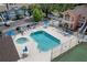 Community pool and tennis court with lounge chairs and hot tub at 3141 Britannia Blvd # D, Kissimmee, FL 34747
