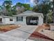 Single-story home with carport and landscaped yard at 32314 Oak Park Dr, Leesburg, FL 34748