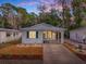 Front view of a single-story home at dusk at 32314 Oak Park Dr, Leesburg, FL 34748