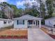 Front view of a house with carport and landscaping at 32314 Oak Park Dr, Leesburg, FL 34748